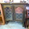 Lighted cabinet would look nice atop another cabinet. Works and measures about 43