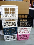 Seven plastic crates are sturdy and in decent shape.