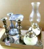 Two oil lamps, pair of candle sticks, and two mismatched candle sticks. Tallest is lamp with shade