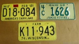 1961 and 1974 Wisconsin license plates, including Farm; 1968 Idaho license plate.