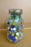 Quart jar of old glass marbles.
