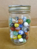 Pint jar of old glass marbles.