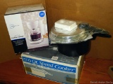 New in box 6 quart Mirro speed cooker and a new in box 12 cup coffee maker.