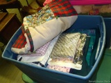20 gallon tote filled with quilting or sewing material, plus a well-loved quilt and some upholstery