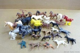 Metal and plastic toy horses, some with Indian riders. Two cast metal horses are marked 'England'.