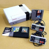 Nintendo Entertainment System is Model NES-001 and dated 1985. Comes with cords and controllers as