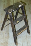 Great little painted two-step stool is about 2' tall. Would make a great display for plants.