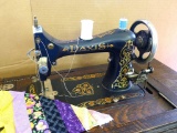 Antique Davis brand treadle sewing machine with cabinet and stand. Machine has nice graphics and