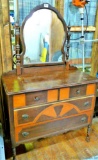 Vintage dresser with mirror has dovetailed drawers. Dresser measures about 40