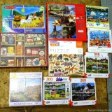 Ten 300, 275, 100, and 500+ piece jigsaw puzzles by Cobble Hill, Bits and Pieces, more. Boxes