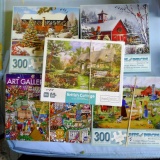 Five 300 piece jigsaw puzzles. Boxes opened, pieces unverified.