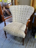 Armchair has beautiful wooden accents, upholstery has some spots but is overall good. Measures about