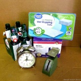 TImex alarm clock, Rival mini chopper, unopened package of wet mop pads, glass bottles with caps,