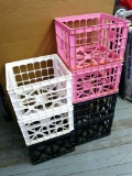 Seven plastic crates are sturdy and in decent shape.