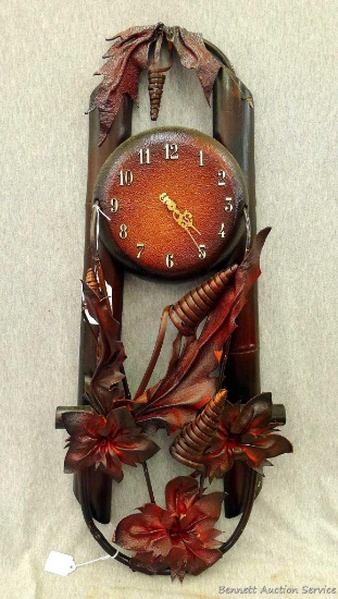 Art deco leather clad quartz wall clock would make a great white elephant present. About 32" long,
