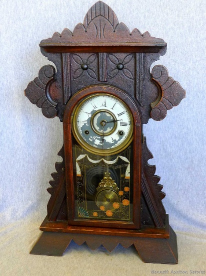 Antique 8 day striking mantle clock by New Haven Clock Co. is in good condition. Measures about 22"
