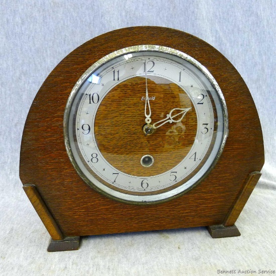 Very neat Enfield mantle clock was made in England. Pretty cabinet in good condition measures about