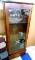 Glass front gun cabinet holds six rifles and has a drawer underneath for pistols, ammunition, or