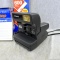 Polaroid instant OneStep camera in original box with manual and 1 package/10 photos of 600 instant