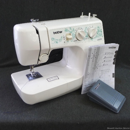 Brother Model LS2350 sewing machine with case, manual and some notions. Machine turns on, lights up,