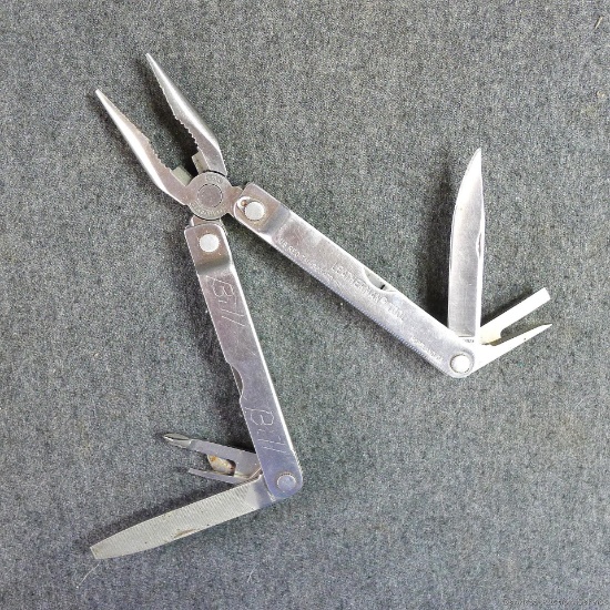 Leatherman multi-tool with leather sheath. Multi-tool measures 6-1/4" as pictured.
