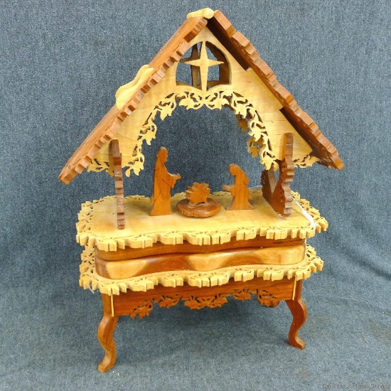 Beautiful wooden music box with intricate scroll work with baby Jesus and Joseph and Mary, plays