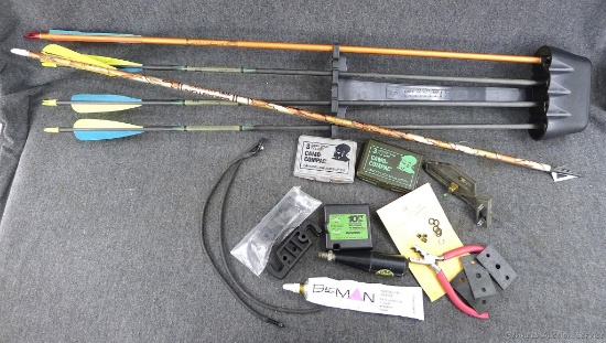 Quiver with 5 broad head Easton arrows, container filled with rangefinder, camo paint and more. A