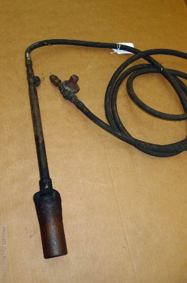 Propane torch has a 19" wand and a questionable hose. Appears to attach to a 20 lb cylinder.