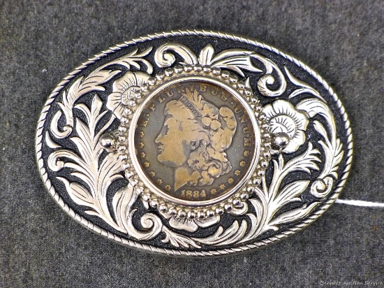 Southwest style belt buckle has what may be a real 1884 Morgan silver dollar. Buckle about 4" x