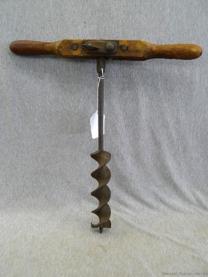 Vintage T-drill with original wooden handle. Measures 18'' long and 17 1/2'' across handle. Wood has