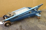 Unmarked hydraulic floor jack is about the size of a 2 ton unit at 24