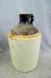 Nice stoneware jug, stands 9'' tall. There is a surface crack on side of the jug, in otherwise good