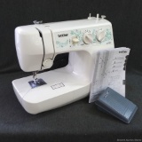 Brother Model LS2350 sewing machine with case, manual and some notions. Machine turns on, lights up,