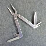 Leatherman multi-tool with leather sheath. Multi-tool measures 6-1/4