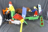 Two fun whirligig yard ornaments incl man sawing wood and girl feeding donkey. Larger about 21