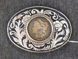 Southwest style belt buckle has what may be a real 1884 Morgan silver dollar. Buckle about 4