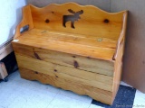 Cute little wooden bench with storage, has a moose cutout on the back; measures 36