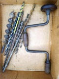 Antique carpenter's brace has walnut handles and brass accents. Comes with a handful of screw tipped