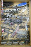 Assorted auto emblems including Ford, Brougham, New Yorker, Oldsmobile, Chevrolet, Chrysler and
