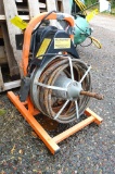 Power sewer auger with foot switch and hand control.
