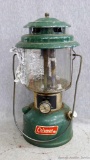 Coleman kerosene lantern, stamped 12 73 on bottom, with Coleman and Pyrex on the glass globe;
