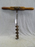 Vintage T-drill with original wooden handle. Measures 18'' long and 17 1/2'' across handle. Wood has