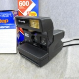 Polaroid instant OneStep camera in original box with manual and 1 package/10 photos of 600 instant
