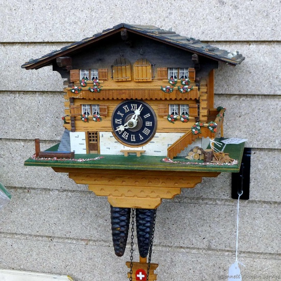 Swiss styled cuckoo clock with 3 weights; measures 10-1/2" x 9". Seller states it runs.