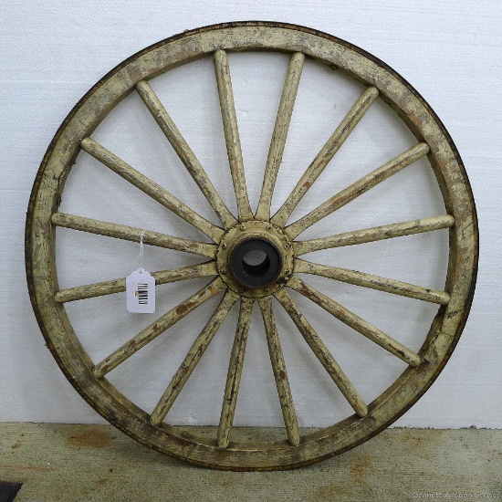 Wooden wagon wheel; measures 27" diameter.
