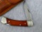 Schrade Uncle Henry folding pocket knife with leather Schrade belt sheath. Knife opens to 6-1/2