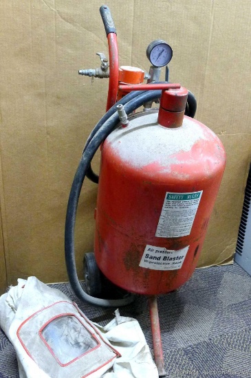 Pressure pot sand blaster with water trap, pressure gauge, and a blasting hood. Stands approx 3'