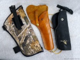 Three larger handgun holsters. Leather one made in Canada and is nice, just needs bottom part of