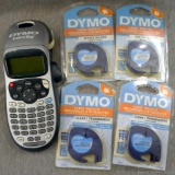 Dymo LetraTag label maker with four packages of label refills. Label maker powers up.