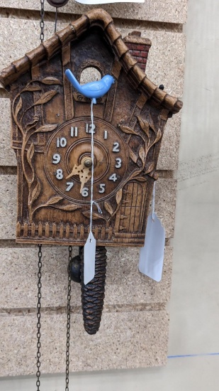 Composite cuckoo clock incl weight and pendulum, and a cheery little blue bird. In good condition,